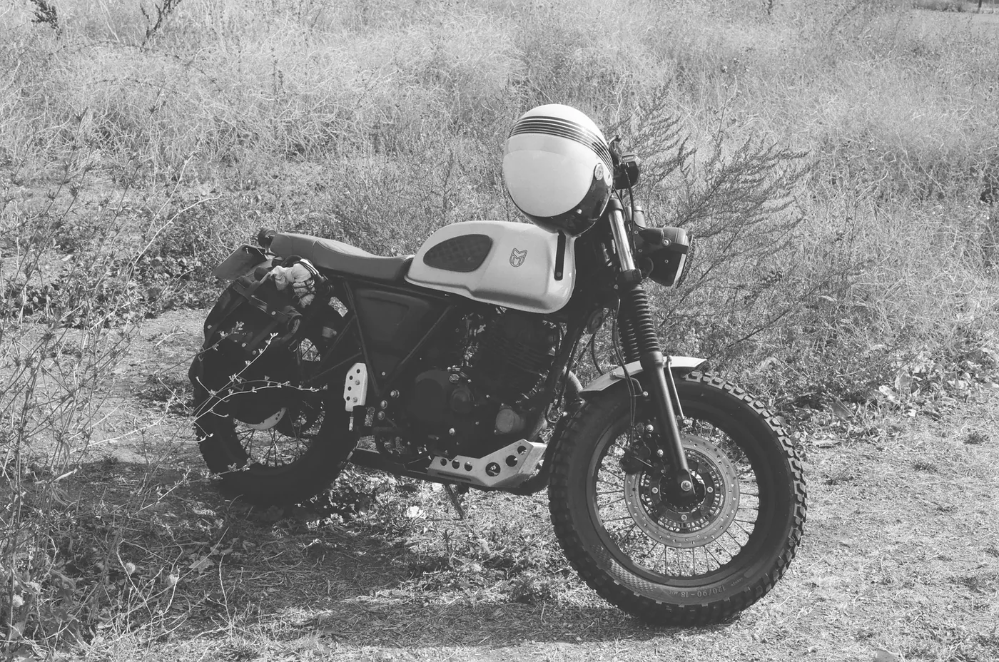 Surhay’s black-and-white motorcycle photograph, with a helmet resting above the fuel tank