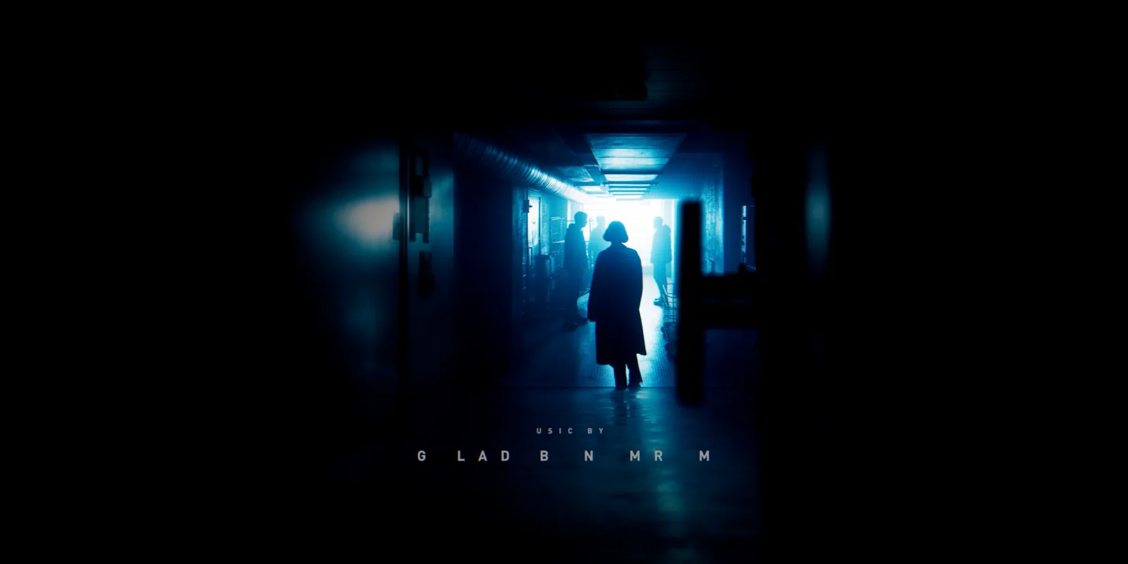 A silhouetted figure in a blue-lit corridor